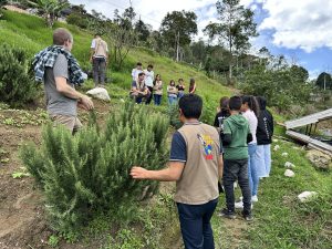 Entrance to Asoprovida's Integral Training Centre in Chinácota, surrounded by mountains and nature.